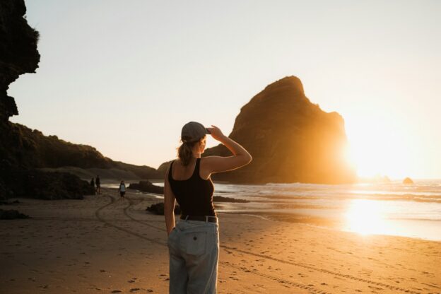 Woman on the beach watching the beautiful sunset.